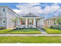 Charming single-story home with a manicured lawn, covered porch, and stone accents, creating inviting curb appeal at 744 Yukon Ln, Debary, FL 32713