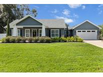 Charming home boasts lush landscaping, well-manicured lawn, and inviting curb appeal at 8717 Se 156Th St, Summerfield, FL 34491