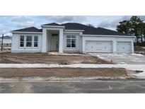 New construction home featuring a three-car garage and a modern white exterior at 960 Hawksnest Pt, Oviedo, FL 32765