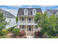 Charming two-story home with a welcoming front porch and second story balcony at 1131 Indigo Dr, Kissimmee, FL 34747