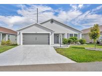 Charming single-story home with well-maintained landscaping and a two-car garage at 1397 Gatlin Pl, The Villages, FL 32163
