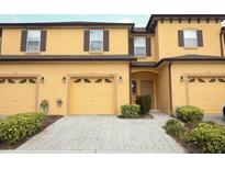 Inviting two-story townhouse with a two-car garage and well-maintained landscaping at 1441 Twin Trees Ln, Sanford, FL 32771