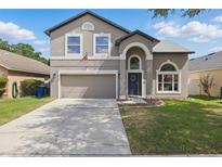 Charming two-story home featuring a well-maintained lawn and a two-car garage at 1758 Bobtail Dr, Maitland, FL 32751