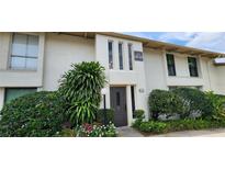 Condo exterior with lush landscaping, mature trees and black trimmed windows at 200 Maitland Ave # 232, Altamonte Springs, FL 32701