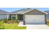 Charming single-story home featuring a two-car garage and beautifully landscaped front yard at 2005 Noble Dr, Davenport, FL 33837