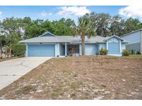 Charming single-story home featuring a well-maintained yard, palm tree, and an attached garage at 2106 Altoona Ln, Deltona, FL 32738