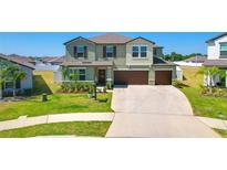 Beautiful two-story home featuring a well-manicured lawn and a two-car garage at 2995 Flying Blackbird Rd, Bartow, FL 33830