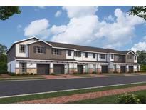 Charming townhome exteriors with attached garages, lush landscaping, and inviting curb appeal at 4287 Campsite Loop, Orlando, FL 32824