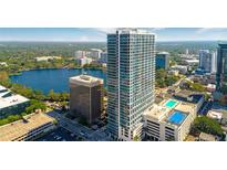 Stunning aerial view of high-rise building with lake and skyline in background at 150 E Robinson St # 2807, Orlando, FL 32801