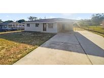 Charming single-story home with a covered carport and a spacious concrete driveway at 1543 Sarah St, Lake Wales, FL 33898
