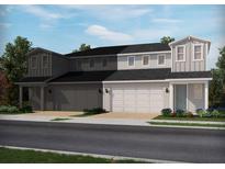 Charming townhouse with a two-car garage and meticulously landscaped front yard at 1805 Archer Dr, Minneola, FL 34715