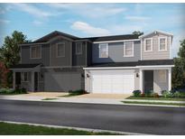 View of two-story townhomes with attached garages, landscaping, and diverse exterior color palettes at 1820 Archer Dr, Minneola, FL 34715