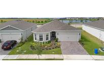 Charming single Gathering home boasting manicured landscaping and neutral paint at 2003 Spring Shower Cir, Kissimmee, FL 34744