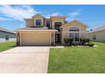 Charming two-story home featuring a well-maintained lawn and a spacious two-car garage at 2655 Star Lake View Dr, Kissimmee, FL 34747