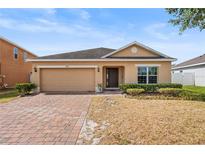 Charming single-Gathering home with manicured front lawn and brick driveway at 3345 Reedy Glen Dr, Kissimmee, FL 34758