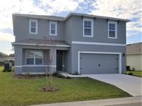 Charming two-story home with a well-maintained lawn and attached two-car garage at 3850 Royal Azalea Way, Sanford, FL 32773