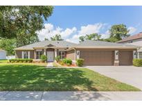 Charming single-story home featuring a two-car garage, lush green lawn, and neatly trimmed landscaping at 530 Heatheroak Cv, Altamonte Springs, FL 32714
