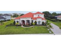Beautiful two-story home featuring a terracotta roof, fountain, and manicured landscaping at 5615 Oxford Moor Blvd, Windermere, FL 34786
