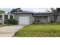 Charming single-story home with a garage, well-maintained lawn, and welcoming curb appeal at 7028 Clarcona Ocoee Rd., Orlando, FL 32818