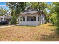 Charming single-story home features a covered porch and neutral exterior paint at 735 N Clara Ave, Deland, FL 32720