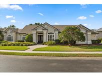 Charming stucco home with well-maintained landscaping and tile roof at 240 Promenade Cir, Lake Mary, FL 32746