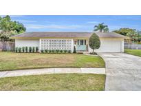 Charming single-story home with white lattice, manicured lawn, and a welcoming blue front door at 2510 Kiowa Trl, Fern Park, FL 32730
