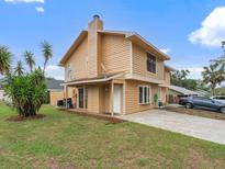 Charming two-story home featuring a manicured lawn and a cozy front porch in a quiet neighborhood at 445 Cottonwood Dr, Altamonte Springs, FL 32714