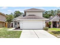 Exterior view of a cozy home with a two-car garage and a charming front yard at 479 Cidermill Place, Lake Mary, FL 32746
