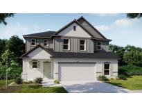 Charming two-story home with a neutral color palette, a two-car garage and beautifully manicured landscaping at 4891 Lyric Dr, Mascotte, FL 34753