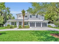 Beautiful two-story home featuring a three-car garage and manicured landscaping at 731 Williams Dr, Winter Park, FL 32789