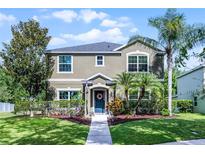 Charming two-story home with a well-manicured lawn and lush landscaping at 913 Bending Oak Trl, Winter Garden, FL 34787