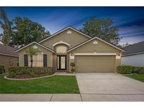 Charming single-story home with manicured lawn, two-car garage, and inviting front entrance at 9545 Southern Garden Cir, Altamonte Springs, FL 32714