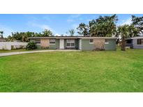 Charming single-story home featuring a well-maintained lawn and stone accents at 1108 Jordan Ave, Orlando, FL 32809