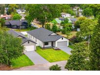 New construction shows manicured lawn, neutral color palette, and thoughtful design for a modern aesthetic at 1109 Naples Dr, Orlando, FL 32804