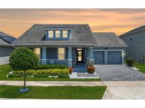 Charming single-Gathering home boasts a two-car garage, a welcoming front porch, and meticulously manicured landscaping at 11927 Charades St, Orlando, FL 32832