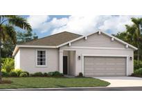 Charming single-story home featuring neutral stucco, a two car garage and tropical landscaping at 1251 Blue Daze Ln, Eustis, FL 32726