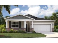 Charming single-Gathering home featuring stone accents, a two-car garage, and a well-manicured lawn at 1252 Blue Daze Ln, Eustis, FL 32726