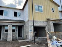 A partially constructed two-story home featuring gray cinder blocks and large window openings ready for customization at 14938 Harvest St, Orlando, FL 32824