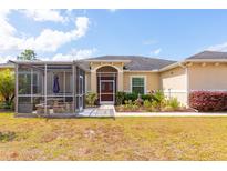 Inviting single-story home featuring a screened patio and well-maintained landscaping at 18920 Overton St, Orlando, FL 32833