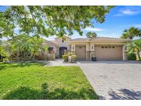 Charming single-story home with well-manicured lawn, brick-paved driveway, and a two-car garage at 196 Torino Ln, Kissimmee, FL 34759