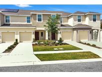Charming townhome exterior boasts neutral colors, well-manicured lawn, and individual driveways at 2029 Crystal Bell St, Orlando, FL 32824