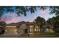 Beautiful home with a tile roof, lush landscaping, and a welcoming entrance at 2241 Lake Vilma Dr, Orlando, FL 32835