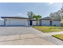 Charming single story home with brick accents, paved driveway, and manicured front lawn at 2803 Tech Dr, Orlando, FL 32817