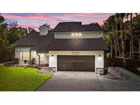 Inviting two-story home featuring a two-car garage and a well-maintained lawn at 302 Hermits Trl, Altamonte Springs, FL 32701