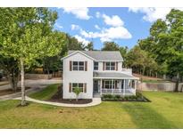 Charming two-story home with a welcoming front porch and well-manicured lawn, perfect for enjoying outdoor living at 32615 Windy Oak St, Sorrento, FL 32776