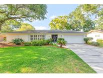 Charming single-story home with a well-maintained lawn, mature trees, and a double door entryway at 4011 Teriwood Ave, Orlando, FL 32812