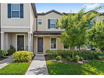 Inviting townhome with manicured landscaping, neutral colors, and covered entry at 5006 Caspian St, St Cloud, FL 34771