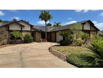 Charming single-Gathering home with a circular driveway and mature landscaping at 872 Huckleberry Ln, Winter Springs, FL 32708