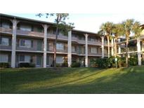 Multi-level building with green shutters, balconies, and well-manicured lawn at 133 Oyster Bay Cir # 330, Altamonte Springs, FL 32701
