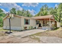 Single story home with a cozy porch and a basketball hoop in the driveway at 18240 Lynbrook Rd, Orlando, FL 32820